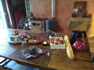 a table with bread and a box of food on it at Les chambres de Kerael in Crozon