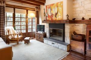 a living room with a fireplace and a tv at Solei by FeelFree Rentals in Garós