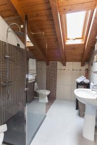 a bathroom with a shower and a toilet and a sink at AcquaTerraFuoco - City apartments in Como