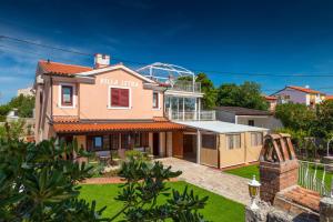 a house with a view of a villa at Guesthouse Mirjana in Premantura