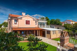 a house with a view of a villa at Guesthouse Istra Premantura in Premantura