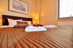 Posteľ alebo postele v izbe v ubytovaní Tartaczna Deluxe Apartments Gdansk