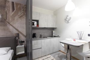 a small bathroom with a sink and a sink at AcquaTerraFuoco - City apartments in Como