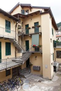 an apartment building with stairs and bikes parked outside at AcquaTerraFuoco - City Apartments in Como