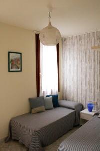 a bedroom with two beds and a window at Bacanal Apartment in Venice