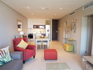 a living room with a red couch and a table at Zimbali Suites 304 in Ballito