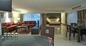 a living room with a couch and a bed at All Seasons Hotel Al Ain - Previously City Seasons in Al Ain