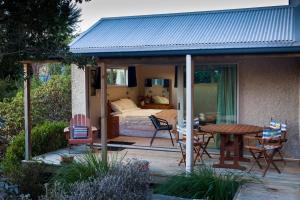 a room with a bed and a table and chairs at For Puffed Pedallers in Mapua