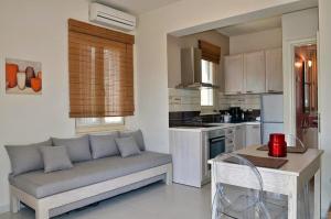 a living room with a couch in a kitchen at Filyra Xenonas in Leonidio