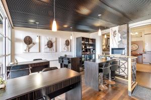 a bar with wooden tables and chairs in a room at The Madsen Boutique Hotel in Penguin