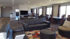a living room with a couch and a table and chairs at Bathurst Gold Panner in Bathurst