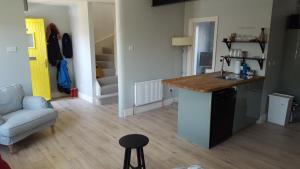 a kitchen and living room with a counter and a couch at Our Holiday Home in Enniscrone