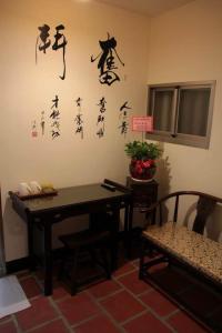 a room with a table and writing on the wall at Teapot House in Jinning