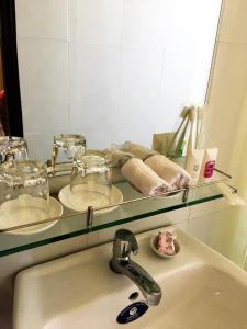 lavabo con estante de cristal encima en Blue Beach Homestay, en Hoi An