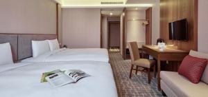 Katil atau katil-katil dalam bilik di Orange Hotel - Wenhua, Chiayi