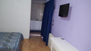 a hotel room with a bed and a television at Hostel can salvado in Cambrils