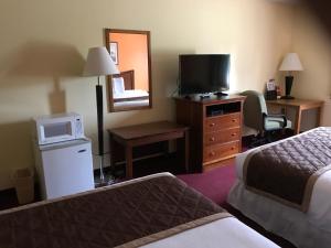 a hotel room with two beds and a television at Lake Tree Inn & Suites in Marion