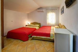 a bedroom with two beds and a window at Apartments Dalila in Ulcinj