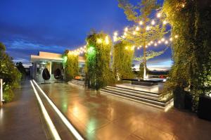 a garden with lights and trees and a building at FM7 Resort Hotel - Jakarta Airport in Tangerang