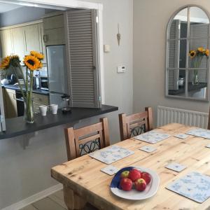a dining room table with a bowl of fruit on it at Beachside Apartment in Bangor +31 photos