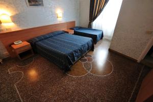 Posteľ alebo postele v izbe v ubytovaní Hotel Miramare