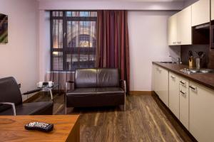 a living room filled with furniture and a tv at Roomzzz Leeds City in Leeds