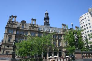 a building with a clock tower on top of it at Quebecs Luxury Apartments in Leeds