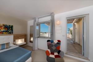 a bedroom with a bed and a window at Artemide Hotel in San Vito lo Capo