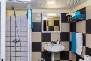 a bathroom with a sink and a mirror at Casa Leonor by Rent2U, Lda in Arco da Calheta +17 photos