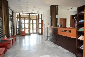 a store lobby with a reception desk and chairs at Hethland Zamárdi VSZ Üdülő in Zamárdi