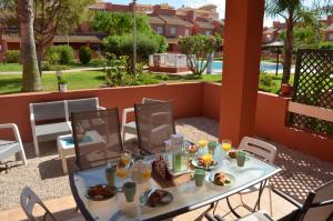 stół z jedzeniem i napojami na patio w obiekcie Albatros Playa 2 - 9408 w mieście Mar de Cristal