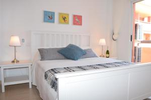 マール・デ・クリスタルにあるAlbatros Playa 2 - 9408の白いベッドルーム(ランプ2つ付)の白いベッド1台