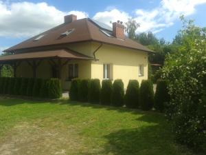 a yellow house with a roof and some bushes at Agroturystyka Agnieszki Murszewskiej in Sandomierz