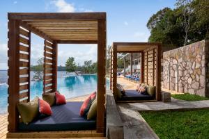 a pair of beds in front of a pool at Independence Hotel Resort & Spa in Sihanoukville +127 photos