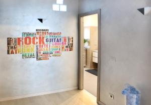 a hallway with a wall with words on it at B&B SanRock in Cuneo