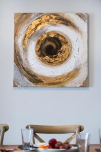 a painting of a spiral on top of a table at Pearl Mansions in Nikiana