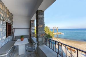 a balcony with a bench and a view of the beach at Moutsouna Beach in Moutsouna Naxos