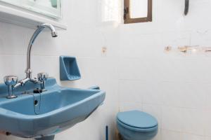 a bathroom with a blue sink and a toilet at Moutsouna Beach in Moutsouna Naxos +100 photos