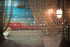 a room with a curtain and a light hanging from it at 亞歷山大汽車旅館 in Kaohsiung