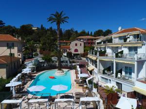 ośrodek z basenem, krzesłami i palmą w obiekcie Boutique Hotel & Spa la Villa Cap Ferrat w mieście Saint-Jean-Cap-Ferrat