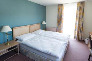Ένα ή περισσότερα κρεβάτια σε δωμάτιο στο Ascott Hotel & Restaurant