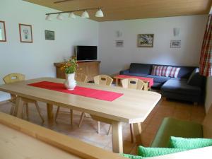 a living room with a table and a couch at Ferienhaus Pfeifer in Gaschurn