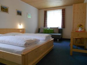 a hotel room with a bed and a couch at Ferienhaus Pfeifer in Gaschurn