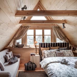 a bedroom with a bed and a couch in a room at GORSKA OSADA Lovely Chalets Zakopane in Poronin