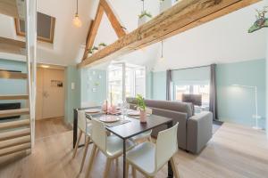 a dining room and living room with a table and a couch at Smartflats - Royal Brussels in Brussels