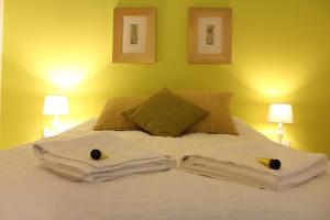 a bed with two towels with two birds on it at The Lodge B&B @ Cannock Chase in Cannock