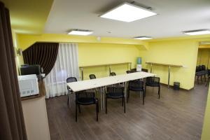 a conference room with a long table and chairs at Rus Hotel in Vladimir