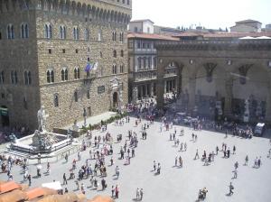 a group of people walking in a plaza in front of a building at Donatello Penthouse in Florence