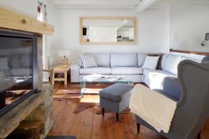 a living room with a couch and a fireplace at Esquirós by FeelFree Rentals in Naut Aran