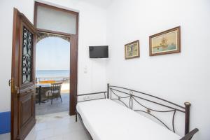a bedroom with a bed and a view of the ocean at Moutsouna Beach in Moutsouna Naxos